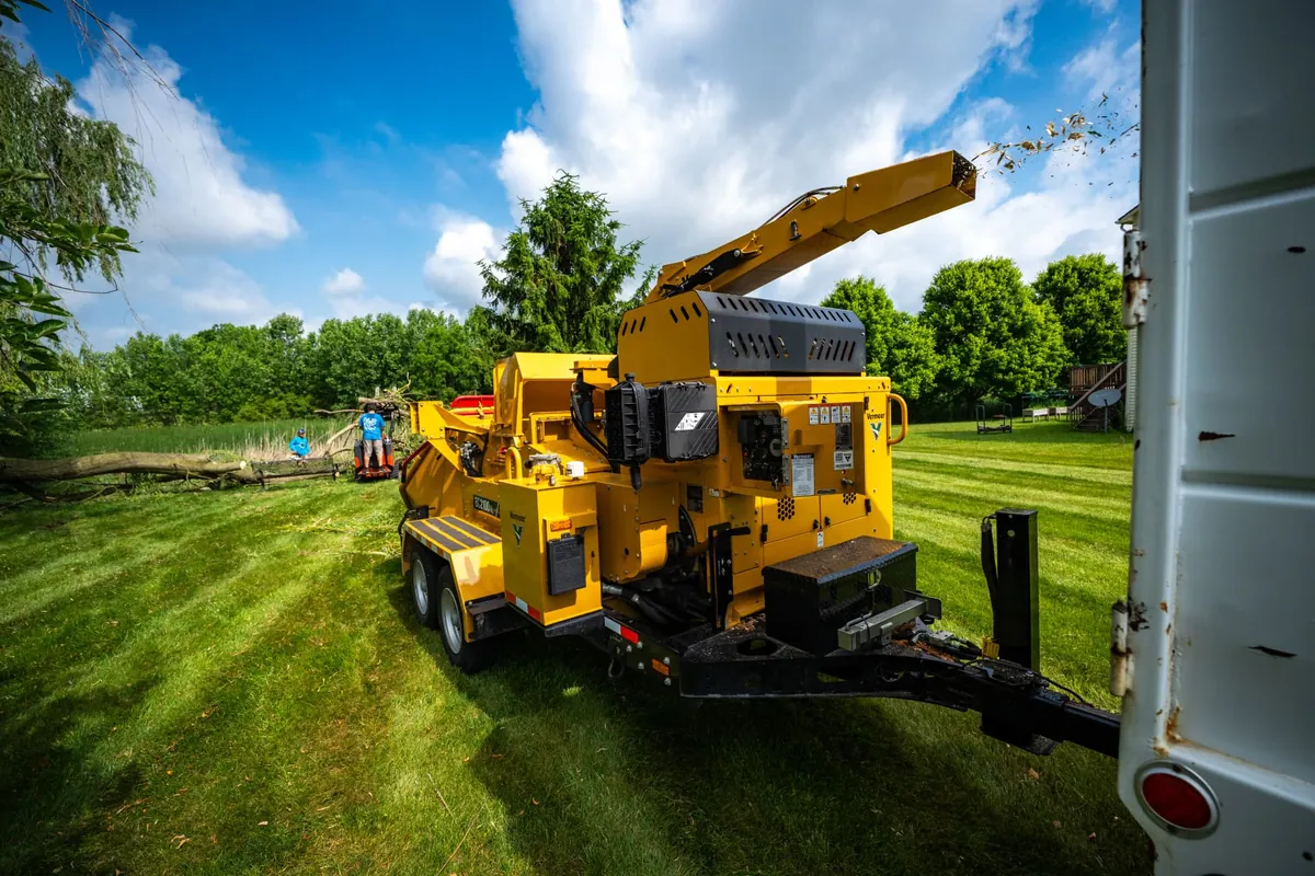 Vermeer wood chipper processing storm debris